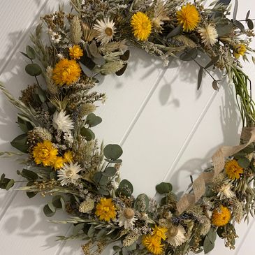A Dried Flower Wreath Made with garden grown dried flowers and eucalyptus on a natural wreath base