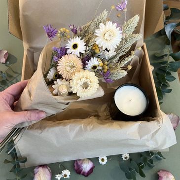 A candle gift box containing an essential oil candle and hand tied home grown dried flower bouquet