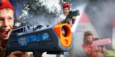 Kids playing laser tag outdoors with colorful equipment and face paint.