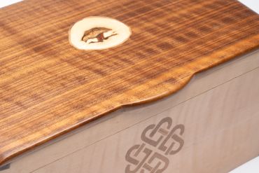 Close-up of a wooden box with smooth edges and a decorative knot.