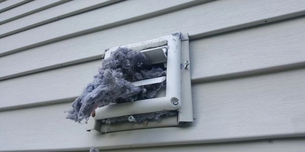 Clogged Dryer Vent Cover on Side of House