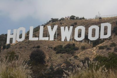 Iconic Hollywood sign on a hillside under a clear sky.