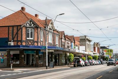 Street with brick buildings and parked cars.