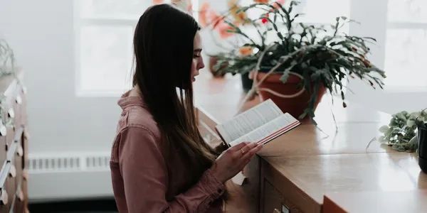 A female with black hair checking in for a psychologist appointment of her chronic illness.