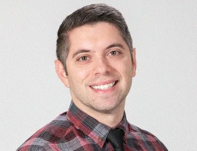 Image of Dr. Spink in a red and black shirt. He is a pain and illness psychologist in New York State