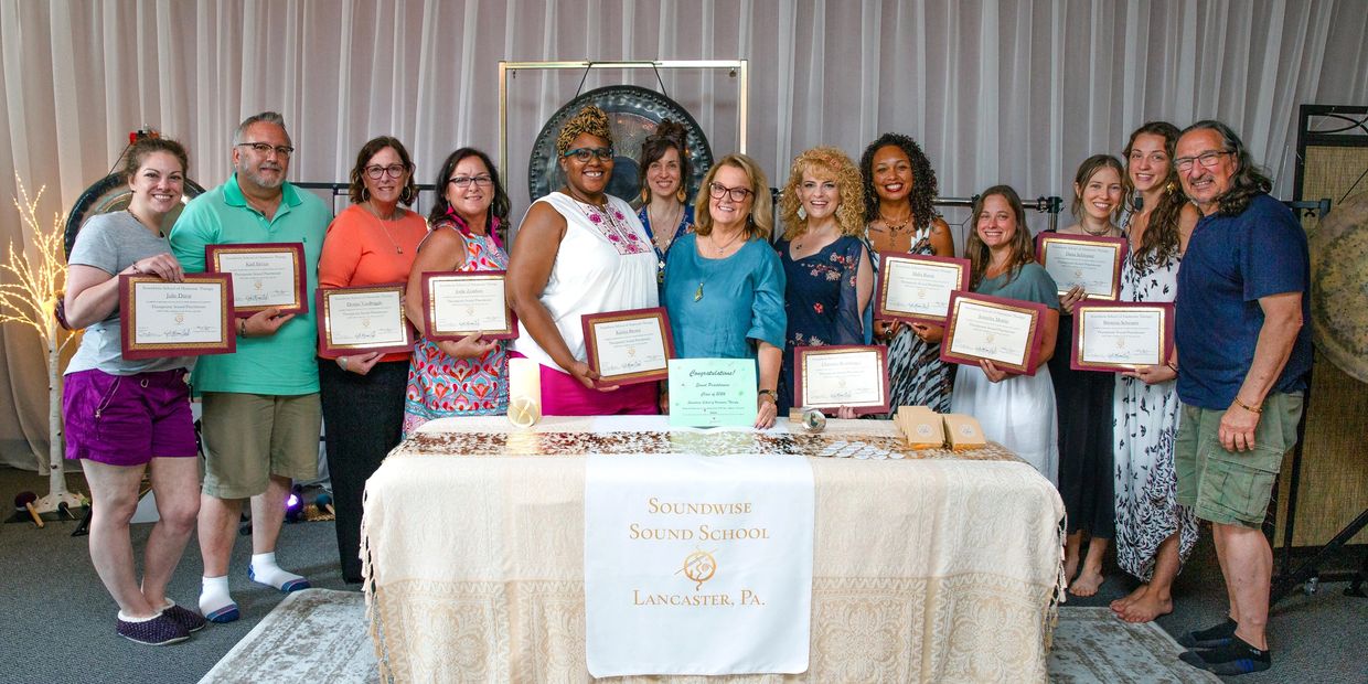 Group of people holding certificates at Soundwise Sound School event.