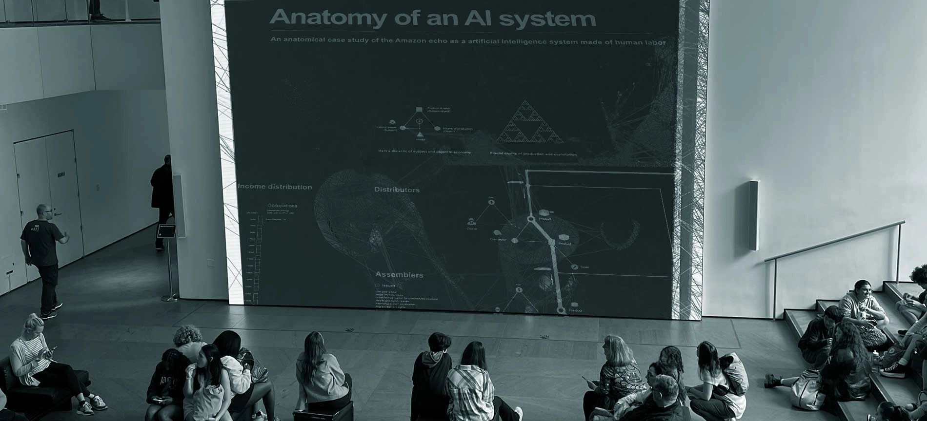 Image of students at a showing of Anatomy of and AI System at a museum.