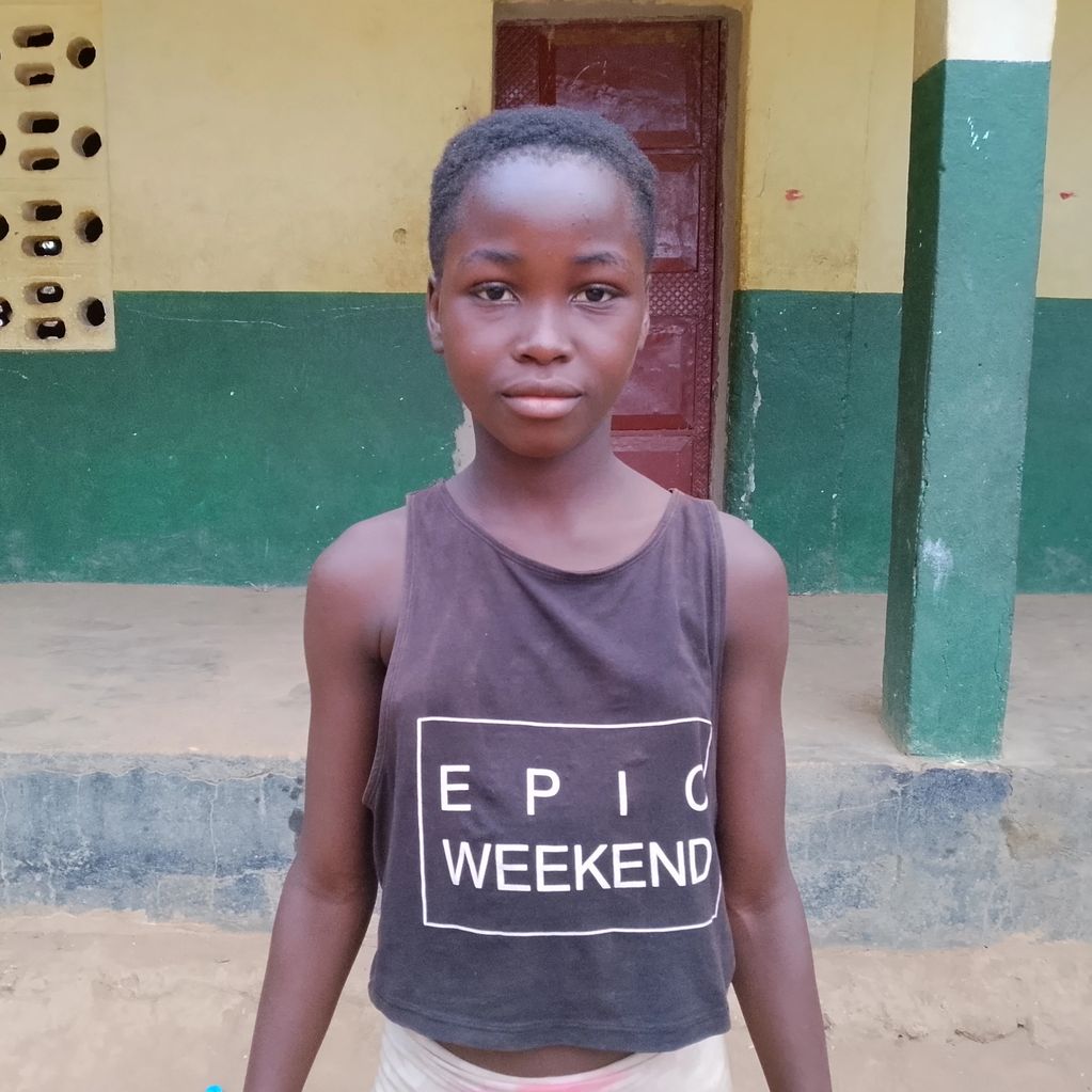 A young girl wearing a black tank top with 'EPIC WEEKEND' written on it.