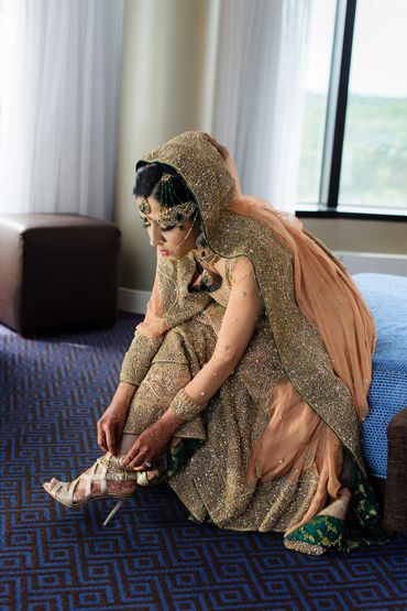 Bride putting shoes on
