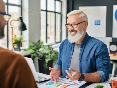 Oregon Graphic Design professional talking to client about R.O.I.