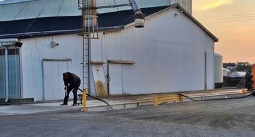 Working on sandblasting a truck scale