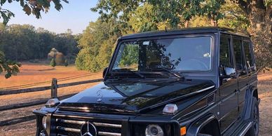 black Mercedes benz g wagon in a field in Greeneville Delaware 
