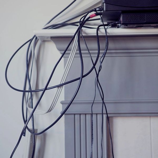 A picture of multiple messy wires on a mantle. 