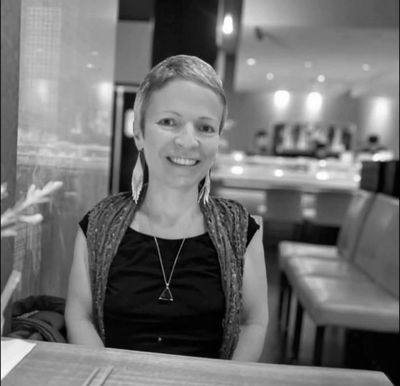 Woman smiling at a restaurant.