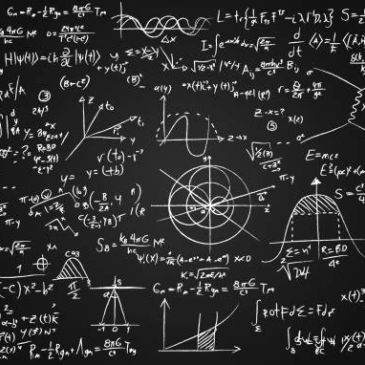 Chalkboard filled with complex mathematical equations and graphs.