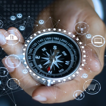 Hand holding a compass surrounded by digital icons and network links.