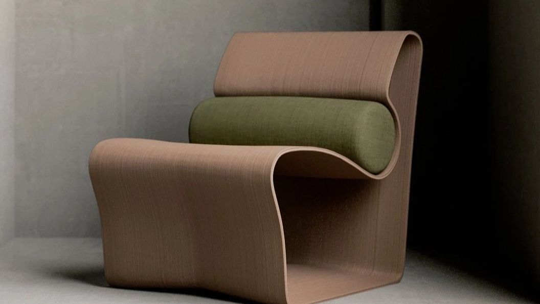 Modern chair with curved wooden design and green cushion.