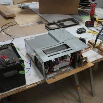 Workbench with old electronic device and tools.