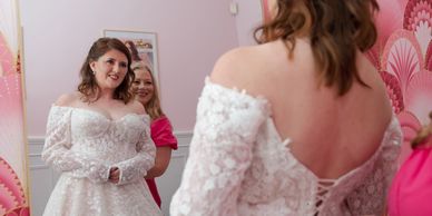 Bride admiring herself in the mirror at Anne Marie Bridal Designs boutique in Winston Salem NC.