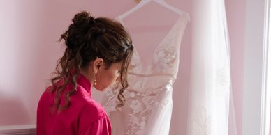 A Winston Salem Bride admiring her wedding gown at Anne Marie Bridal Designs.
