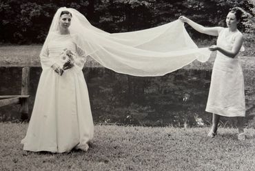 Bride with her bridesmaid in a custom designed wedding gown.