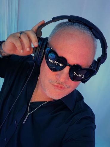 Man wearing headphones and sunglasses.