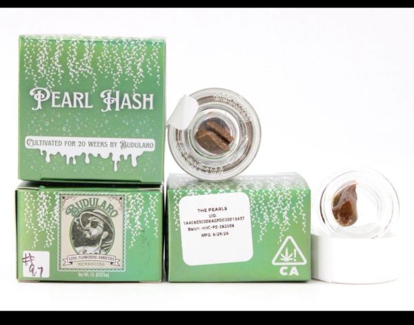 Green packaging of Pearl Hash cannabis product with glass containers.
