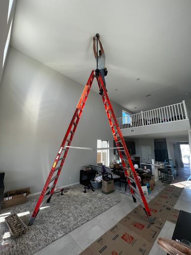 Man Working on a Ladder in a Living Room