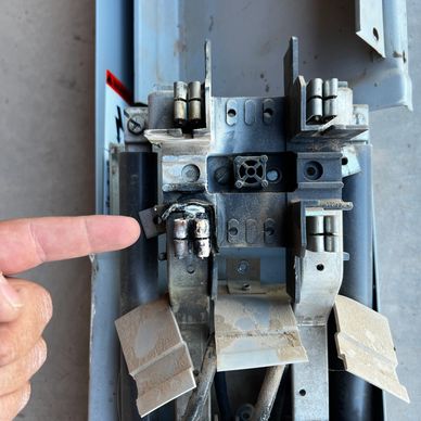 Person's Finger Pointing at a Piece of Metal