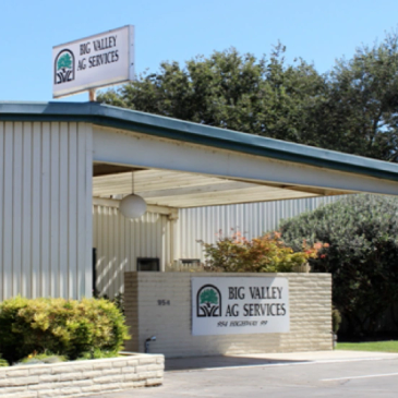 Exterior of Big Valley Ag Services building with signage and greenery.