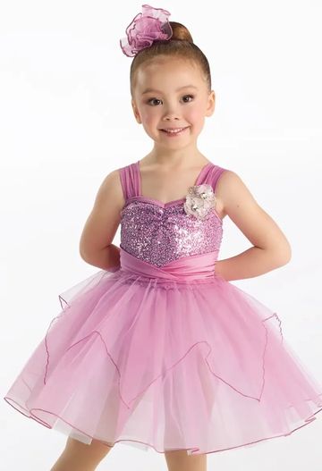 Young girl in a pink ballerina dress posing.