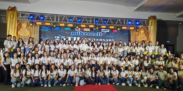 Large group photo celebrating Mikrocell's 25th anniversary event.