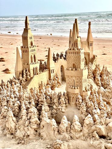 Sandcastle on the beach with waves south padre island