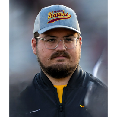 Man wearing glasses and Ankeny Hawks cap.