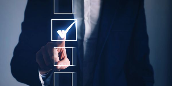 Businessman selecting a checkbox with a glowing checkmark.
