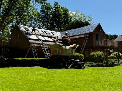 Workers installing a new roof on a house.
