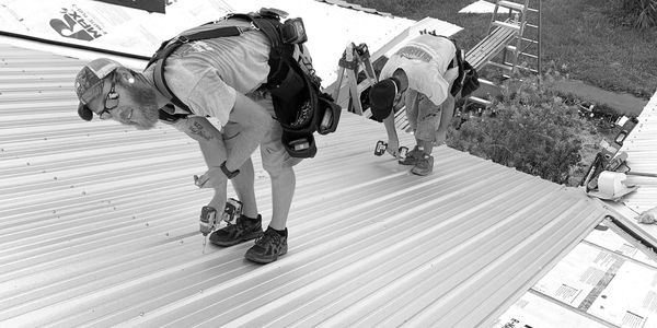 workers installing a metal roof
