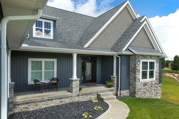 beautiful home with Board & Batten siding and stone veneers