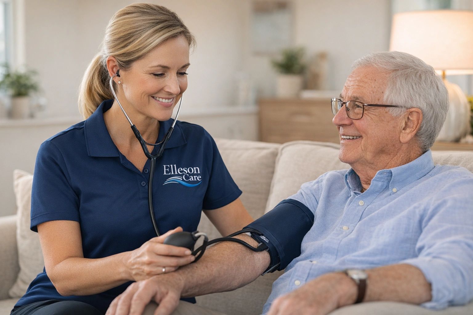 A caregiver measures an elderly man's blood pressure at home.