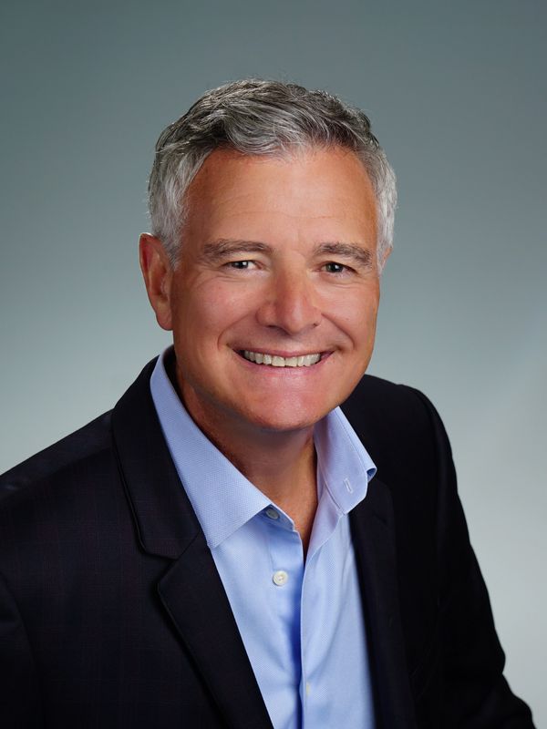 Smiling middle-aged man in business attire.