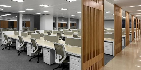 Modern office workspace with rows of desks and ergonomic chairs.