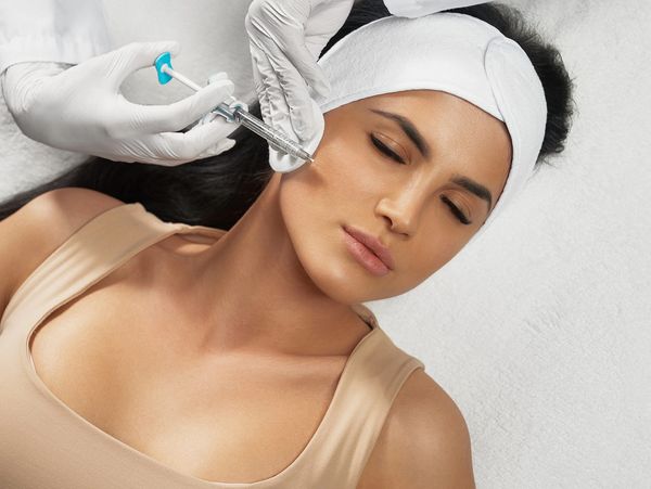 Woman having a dermal filler treatment at a beauty saloon