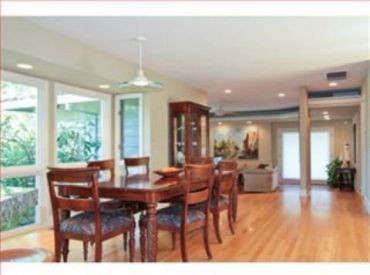 Dining room with freshly painted cream walls, wood table and chairs, and hardwood flooring - interio