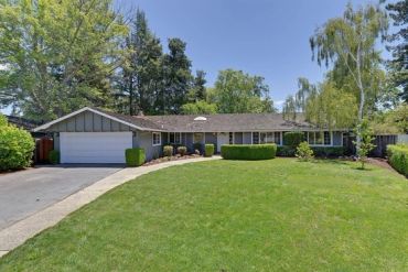 Ranch-style home exterior with freshly painted light gray siding and white trim, two-car garage and