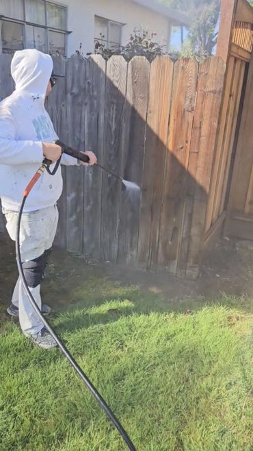 Spray-applied fence staining in a backyard, San Jose, CA (Bay Area) — A&R Bentley Painting