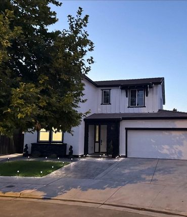 Finished blue two-story home exterior repaint with A&R Bentley truck in the driveway