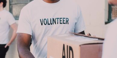 Volunteer holding aid box.