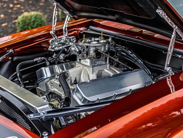 Detailed view of a polished car engine under an open hood.