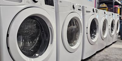 Front-load washing machines getting annual maintenance in Maryville, MO.