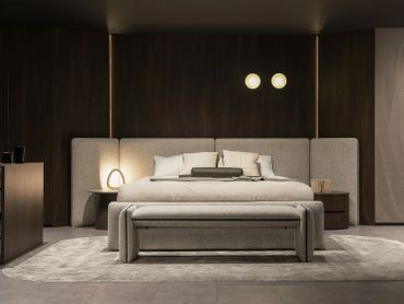 Modern bedroom with muted tones and soft lighting.